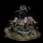 Tabletop miniature diorama featuring a blue and gold armored robot hovering above four purple-crowned dinosaur creatures on a weathered terrain base with abandoned machinery and structures