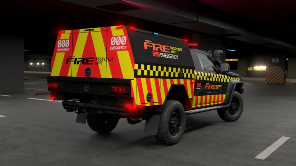 Rear three-quarter view of a Ford Ranger Super Duty fire response vehicle with high-visibility yellow and red checkered livery, parked in an underground garage at night with emergency lights illuminated