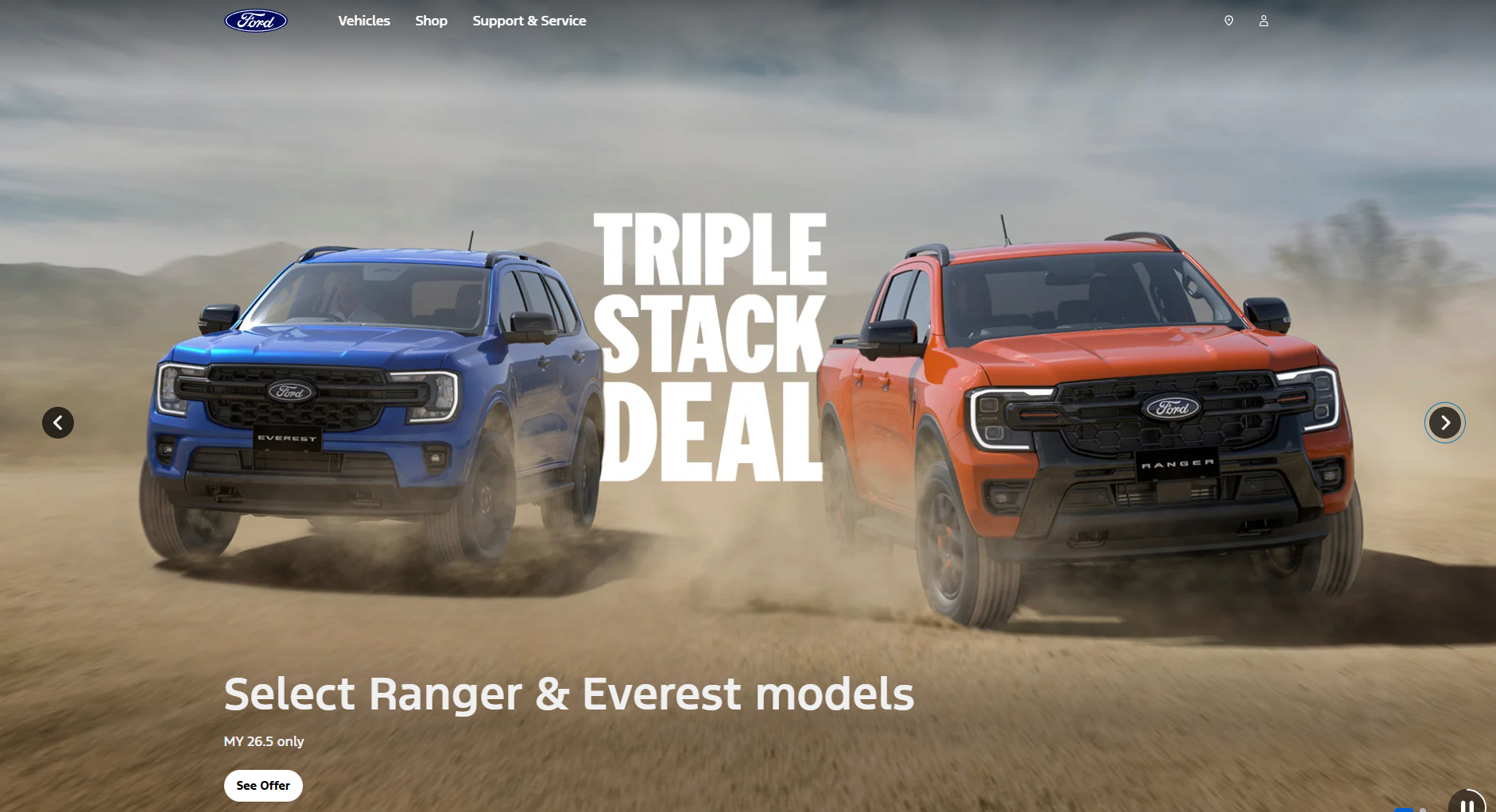 Two Ford trucks, a blue Everest and orange Ranger, driving through dusty terrain with 'Triple Stack Deal' promotional text overlay